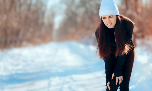 Woman in pain in the snow