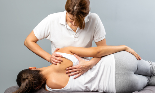 Woman receiving a chiropractic adjustment 