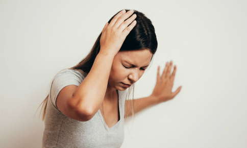 Woman experiencing vertigo