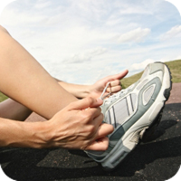 image of person putting on a shoe.