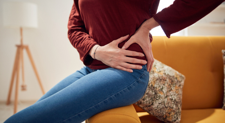 Woman holds her painful hip.