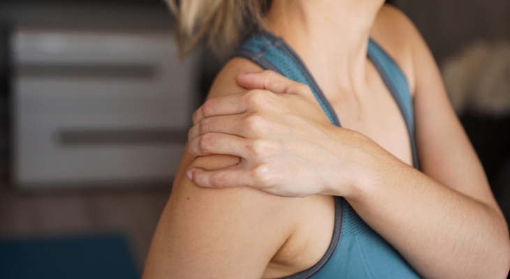 Woman experiencing frozen shoulder